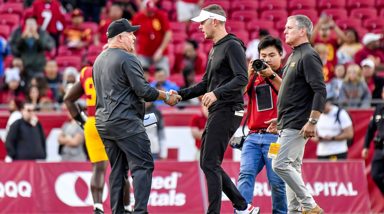 UCLA coach Chip Kelly greets USC coach Lincoln Riley after the 2023 rivalry game.