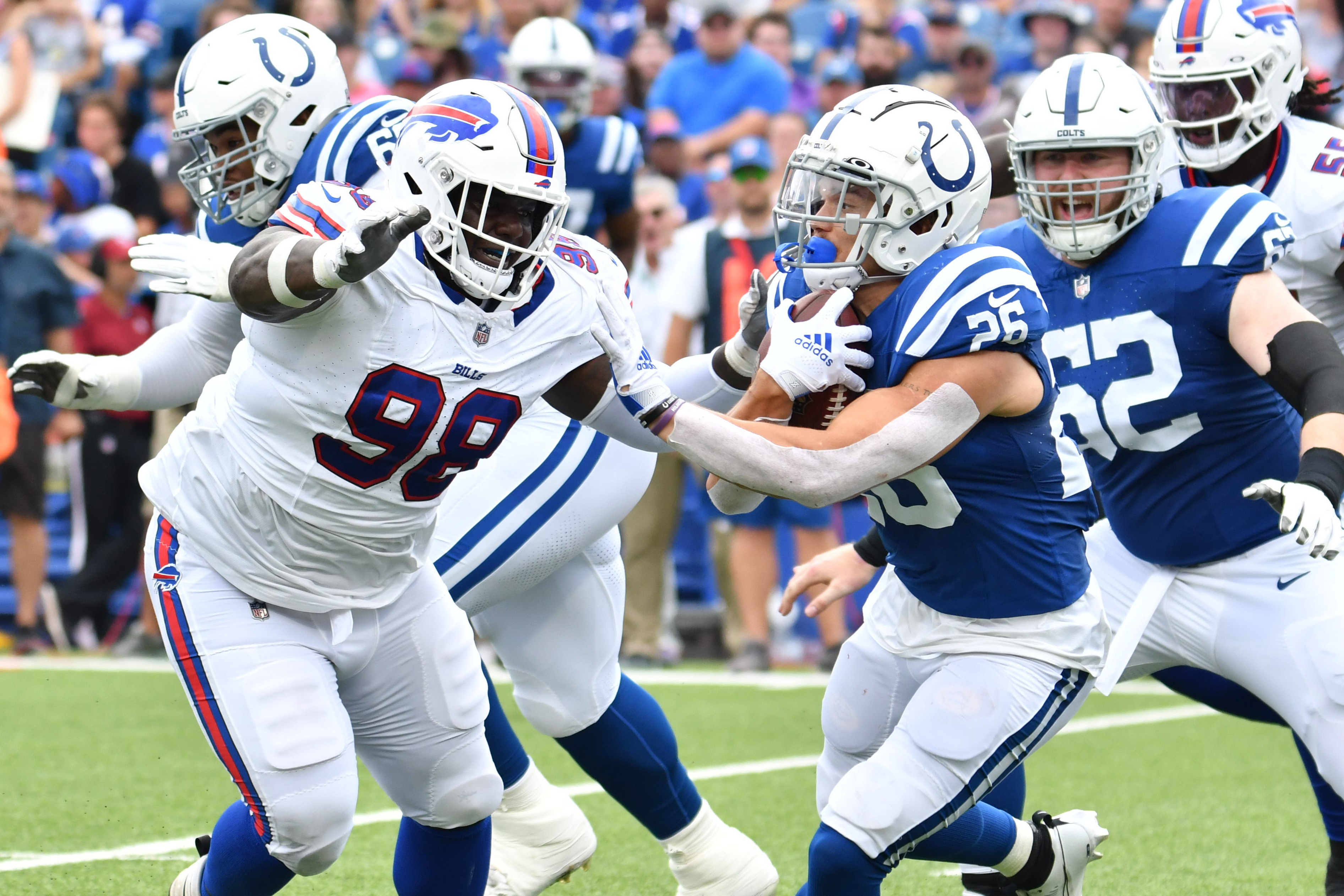 Indianapolis Colts running back Evan Hull (26) runs the ball against Buffalo Bills defensive tackle Poona Ford (98) in the second quarter of a preseason game at Highmark Stadium.