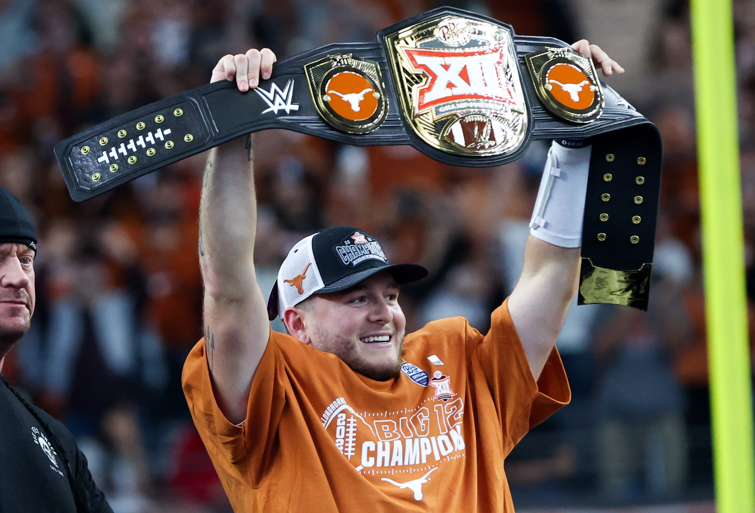 Dec 2, 2023; Arlington, TX, USA; Texas Longhorns quarterback Quinn Ewers (3) holds up the WWE Big 12 championship belt after the win against the Oklahoma State Cowboys at AT&T Stadium.