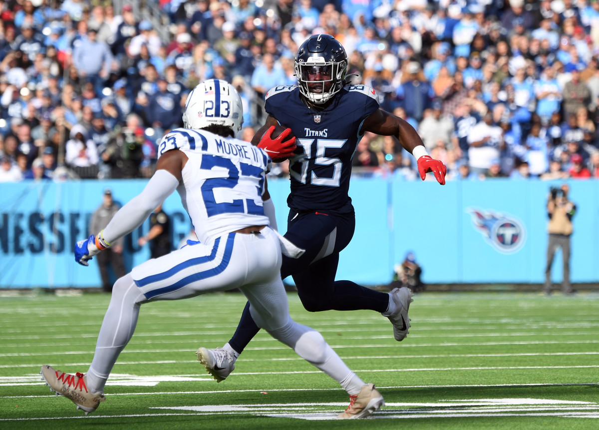 Dec 3, 2023; Nashville, Tennessee, USA; Tennessee Titans tight end Chigoziem Okonkwo (85) runs for a short gain before being tackled by Indianapolis Colts cornerback Kenny Moore II (23) during the first half at Nissan Stadium.
