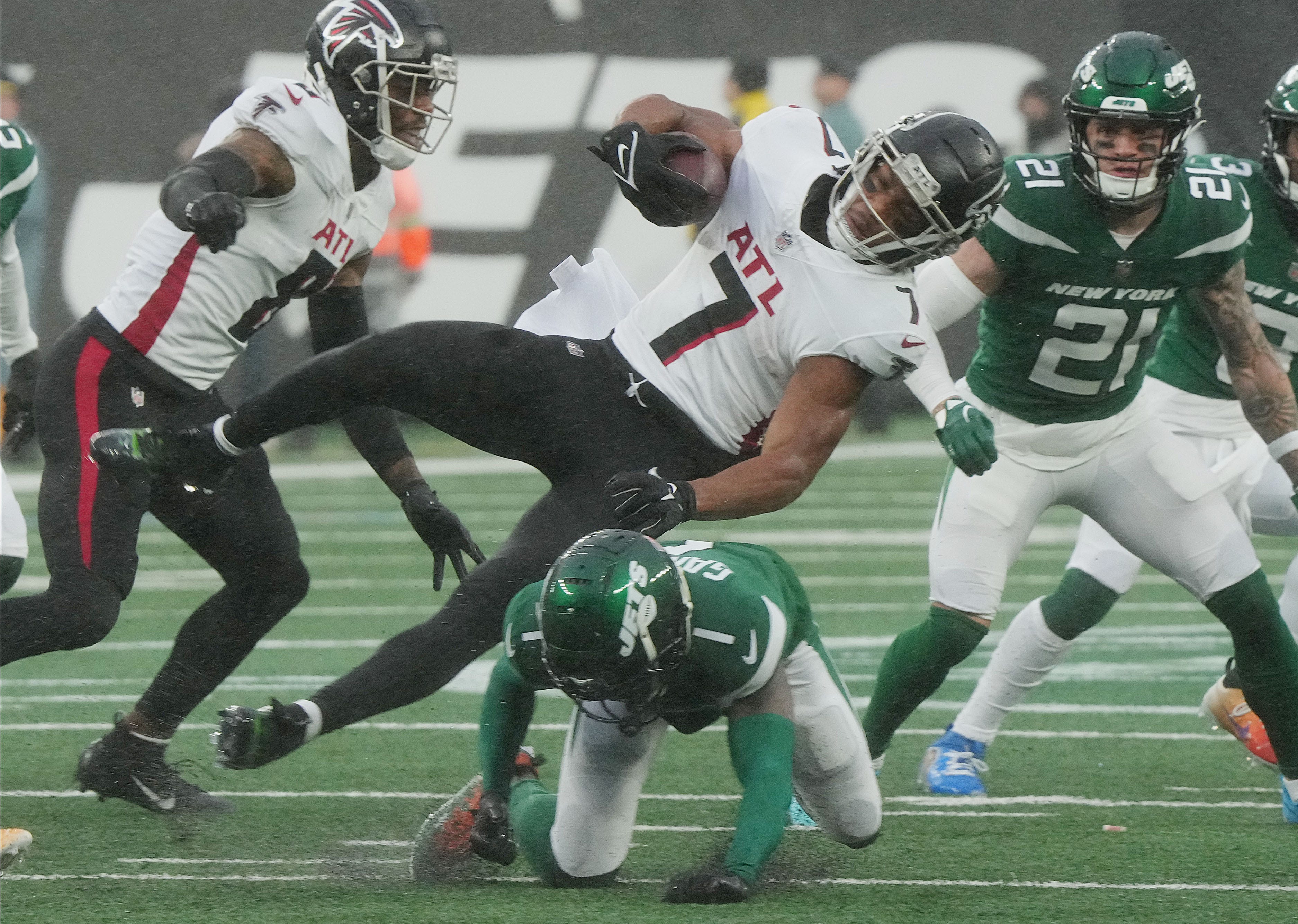 East Rutherford, NJ December 3, 2023 -- Bijan Robinson of the Falcons is upended by Sauce Gardner of the Jets in the second half. The Atlanta Falcons and the NY Jets play at MetLife Stadium on December 3, 2023 in East Rutherford, NJ.