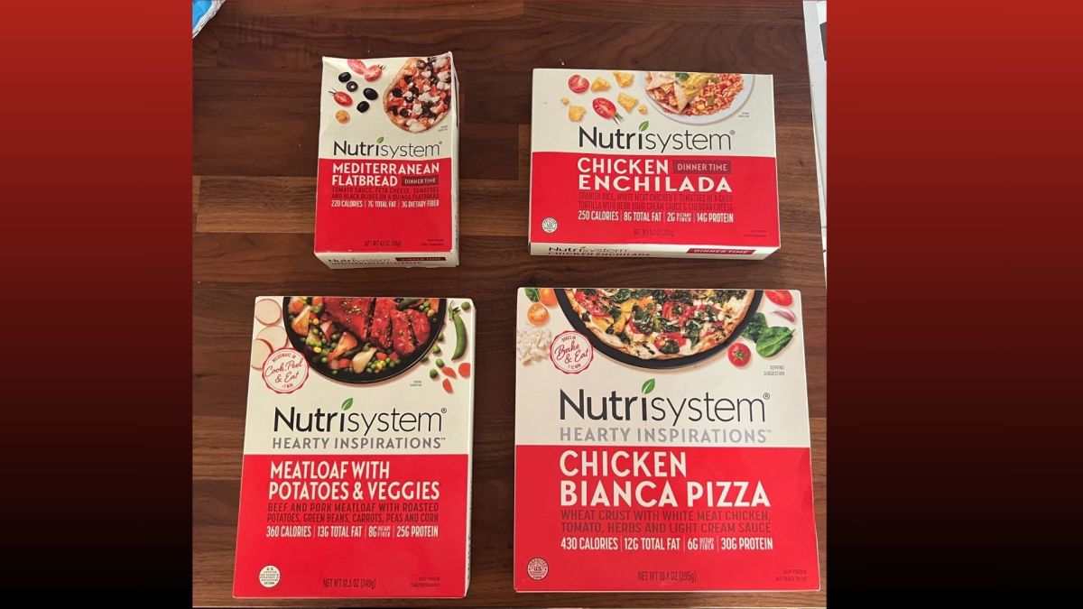 Photo of four Nutrisystem meals in red and white packaging on a table