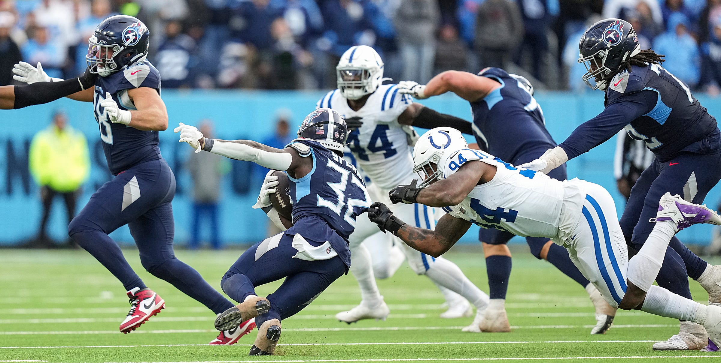 Tennessee Titans running back Tyjae Spears (32) slips away from Indianapolis Colts defensive end Tyquan Lewis (94) Sunday, Dec. 3, 2023, at Nissan Stadium in Nashville, Tenn. The Colts won in overtime, 31-28.