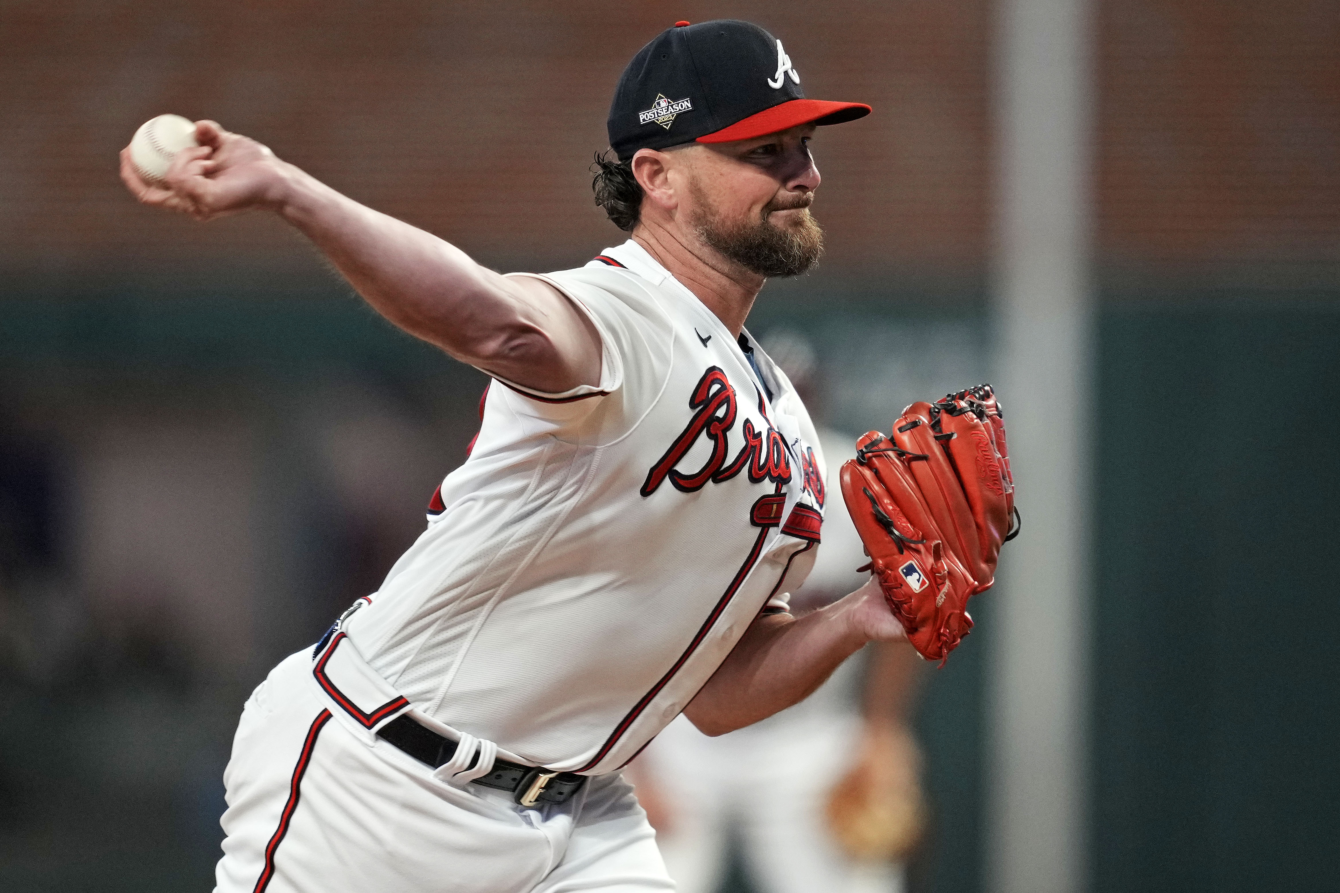 Oct 9, 2023; Cumberland, Georgia, USA; Atlanta Braves relief pitcher Kirby Yates (22) pitches during the fifth inning against the Philadelphia Phillies in game two of the NLDS for the 2023 MLB playoffs at Truist Park.