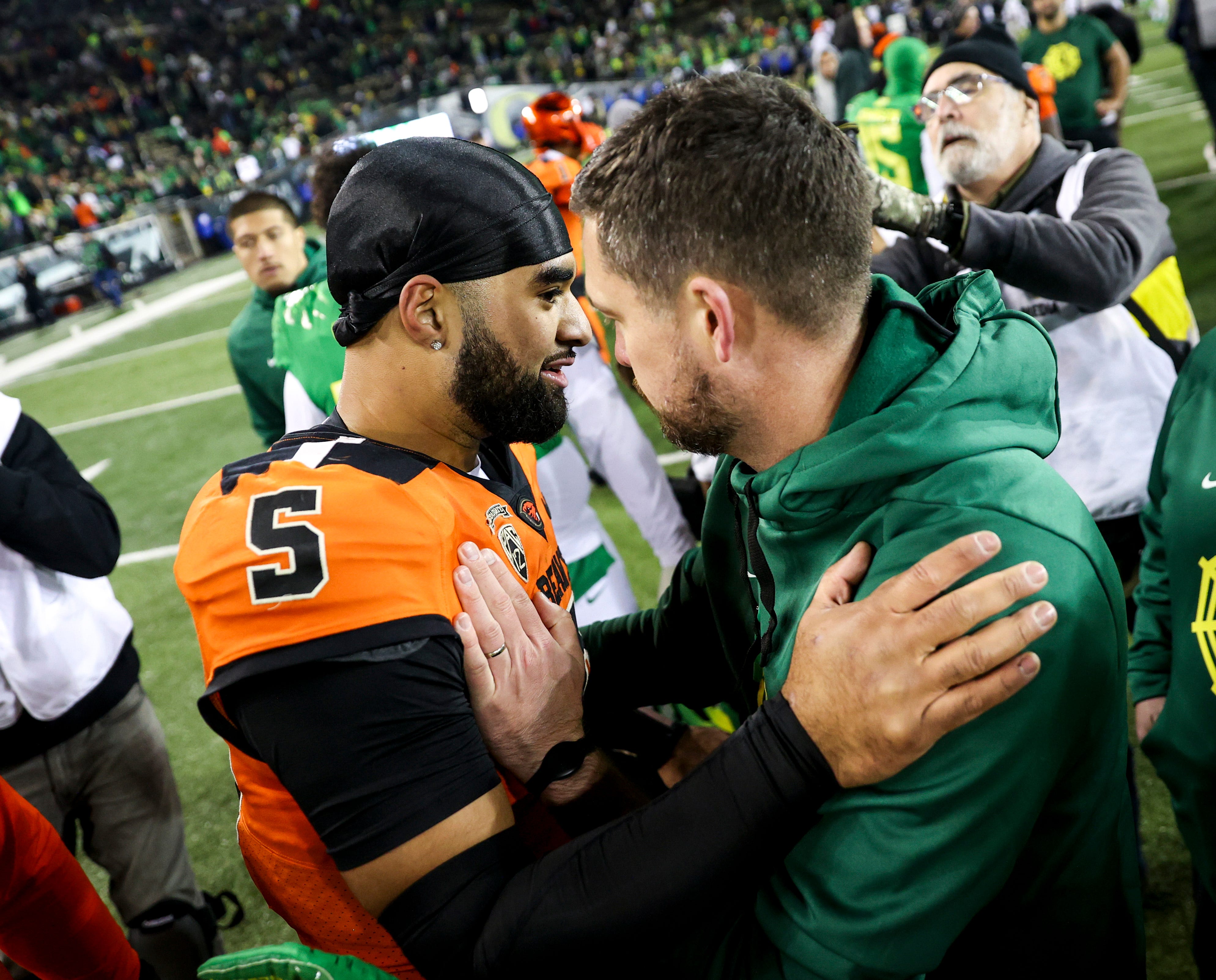 Oregon State Beavers quarterback DJ Uiagalelei meets with Dan Lanning after a game against the Oregon Ducks.