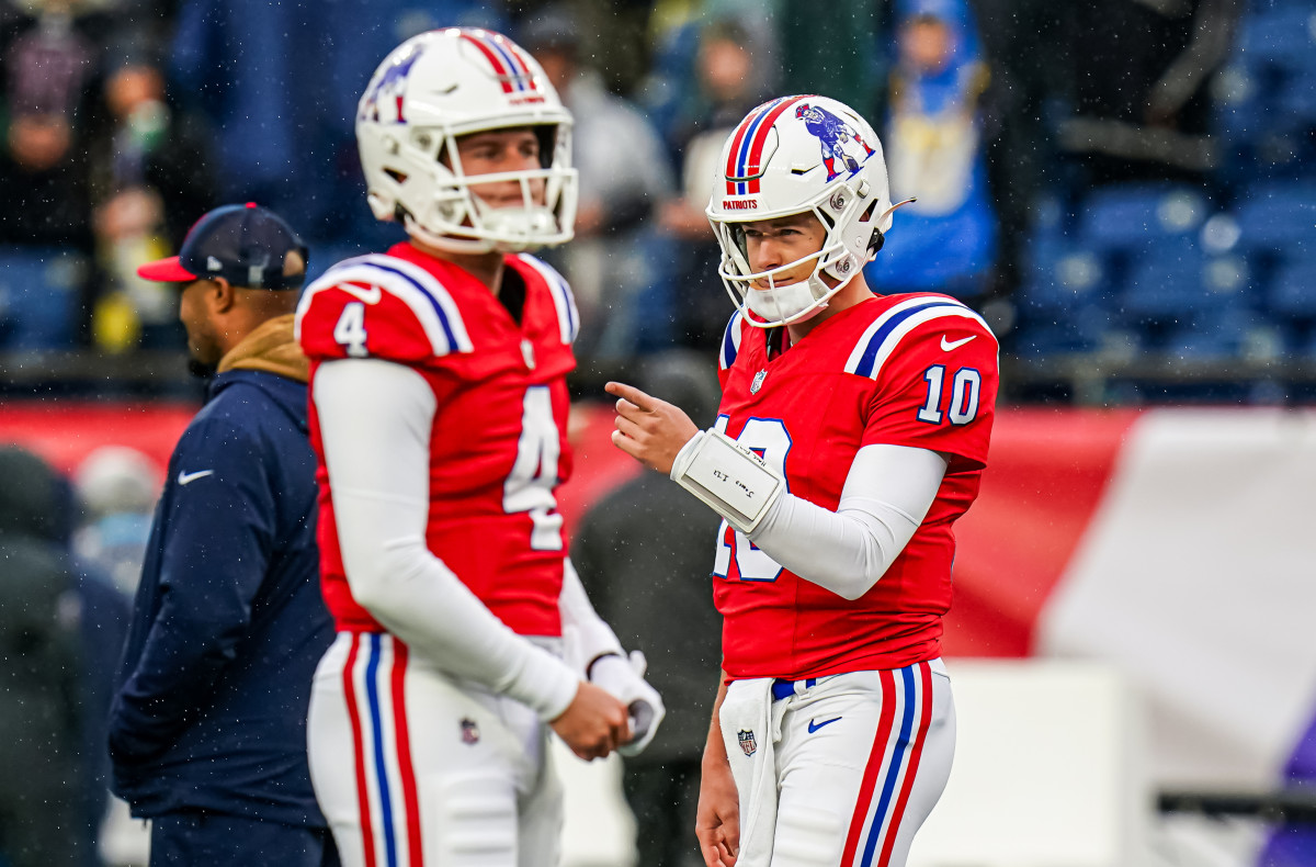 New England Patriots quarterback Mac Jones (10) and quarterback Bailey Zappe (4) in the field to warm up before the start of the game against the Los Angeles Chargers at Gillette Stadium.
