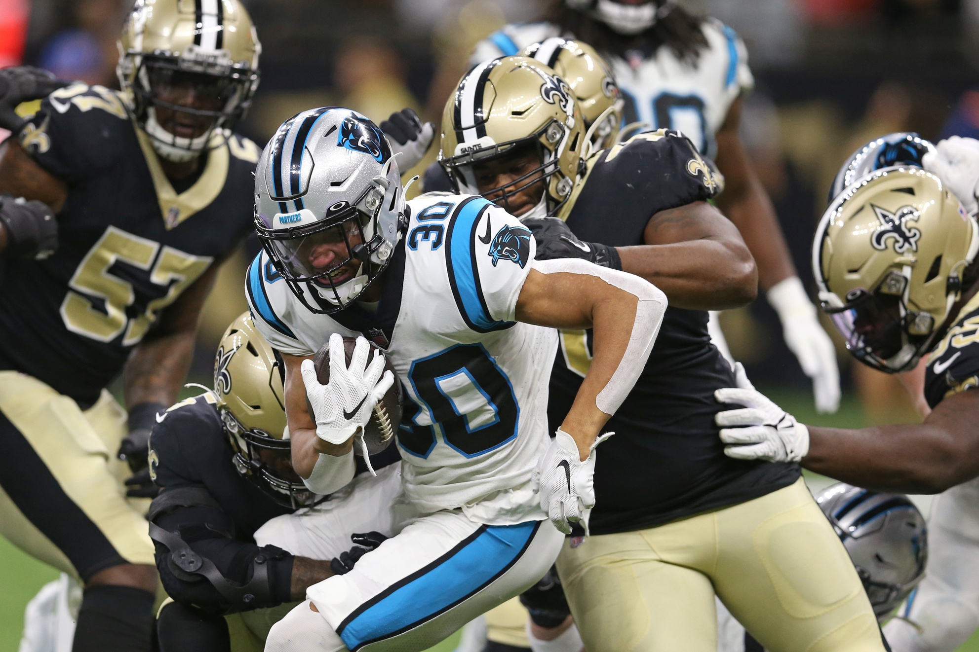 Carolina Panthers running back Chuba Hubbard (30) is tackled by several New Orleans Saints. Mandatory Credit: Chuck Cook-USA TODAY Sports