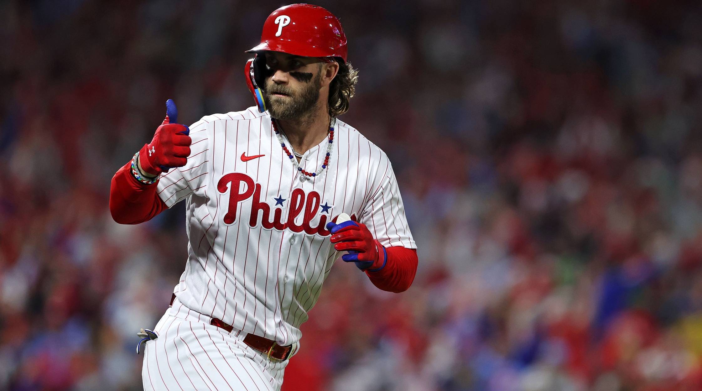 Phillies star hitter Bryce Harper gives a thumbs up to the dugout after hitting a home run.