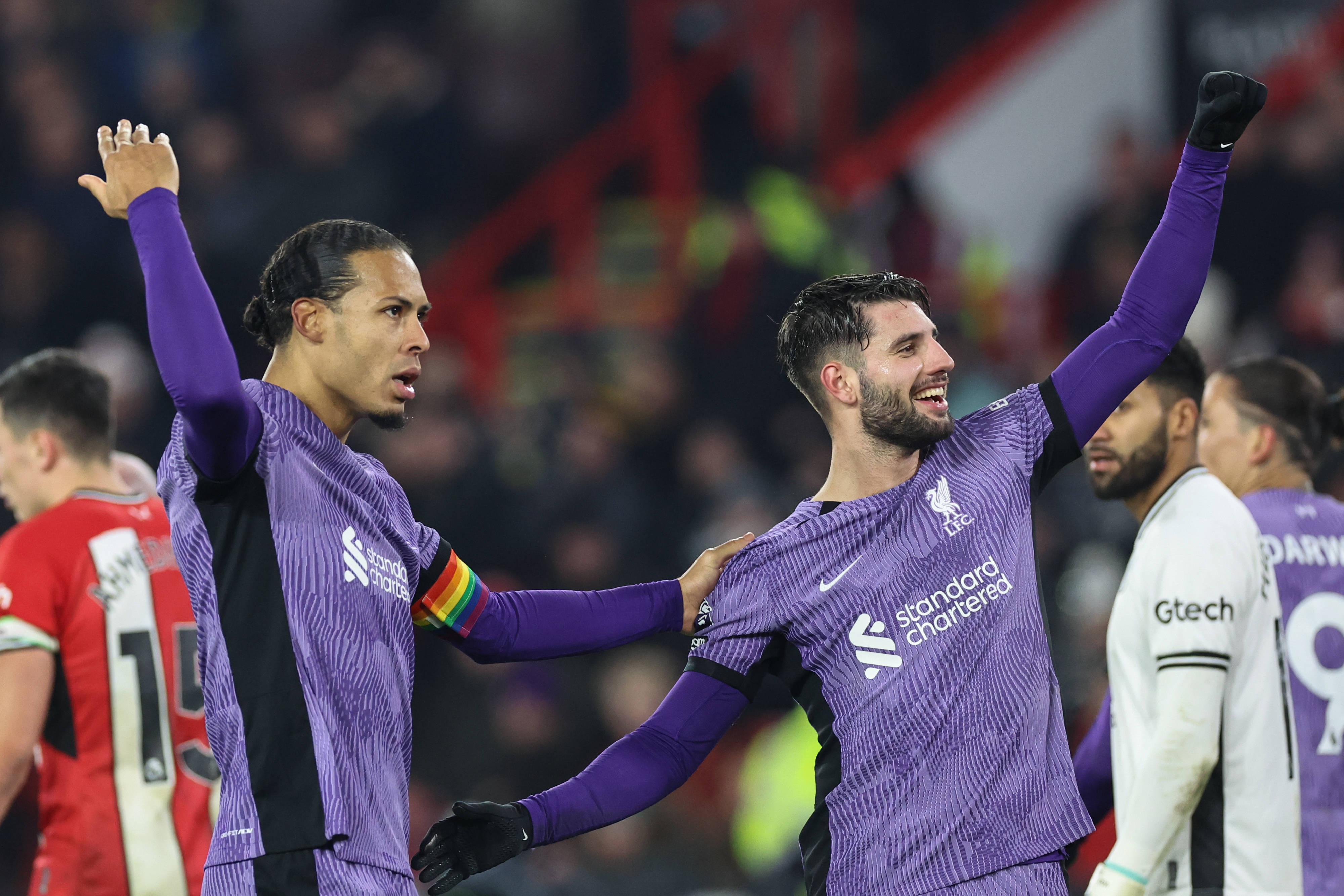 Virgil van Dijk (left) and Dominik Szoboszlai (right) pictured celebrating a goal during Liverpool's 2-0 win at Sheffield United in December 2023