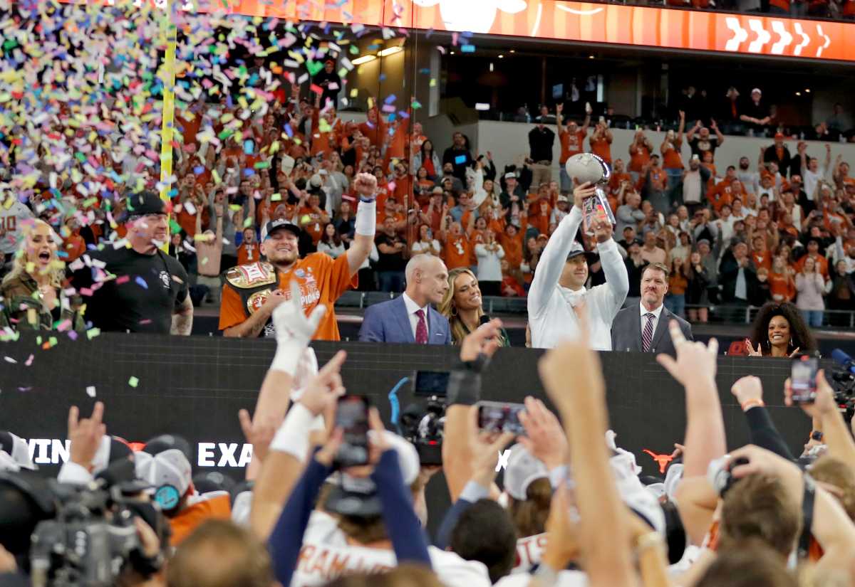 Texas head football coach Steve Sarkisian holds up the Big 12 Football Championship trophy following the Oklahoma State University Cowboys and the Texas Longhorns at the AT&T Stadium in Arlington, Texas, Saturday, Dec. 2, 2023.