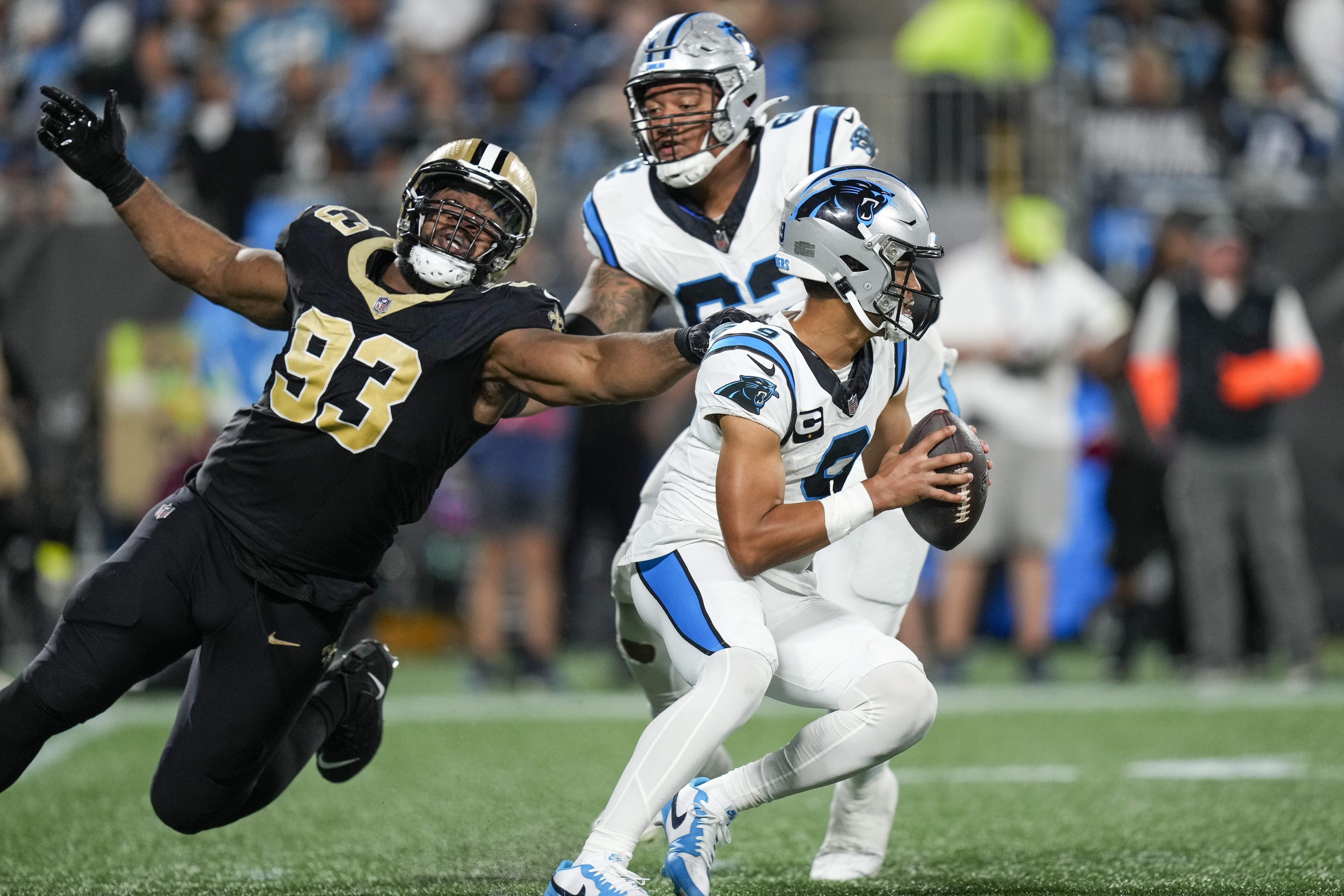 Carolina Panthers quarterback Bryce Young (9) tries to escape New Orleans Saints defensive tackle Nathan Shepherd (93). Mandatory Credit: Jim Dedmon-USA TODAY Sports