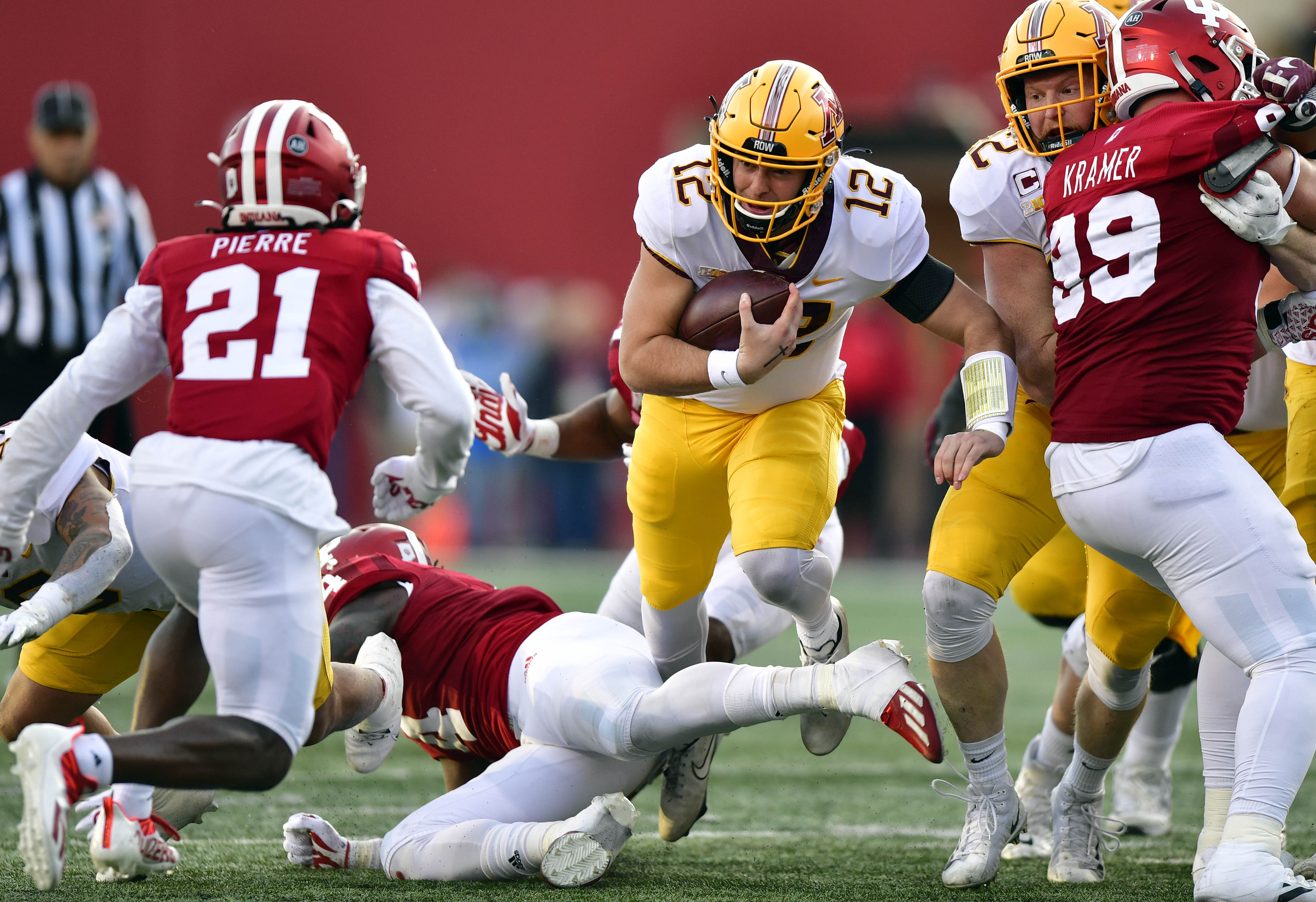 Nov 20, 2021; Bloomington, Indiana, USA; Minnesota Golden Gophers quarterback Cole Kramer (12) finds a hole in the Indiana Hoosiers during the second quarter at Memorial Stadium. 