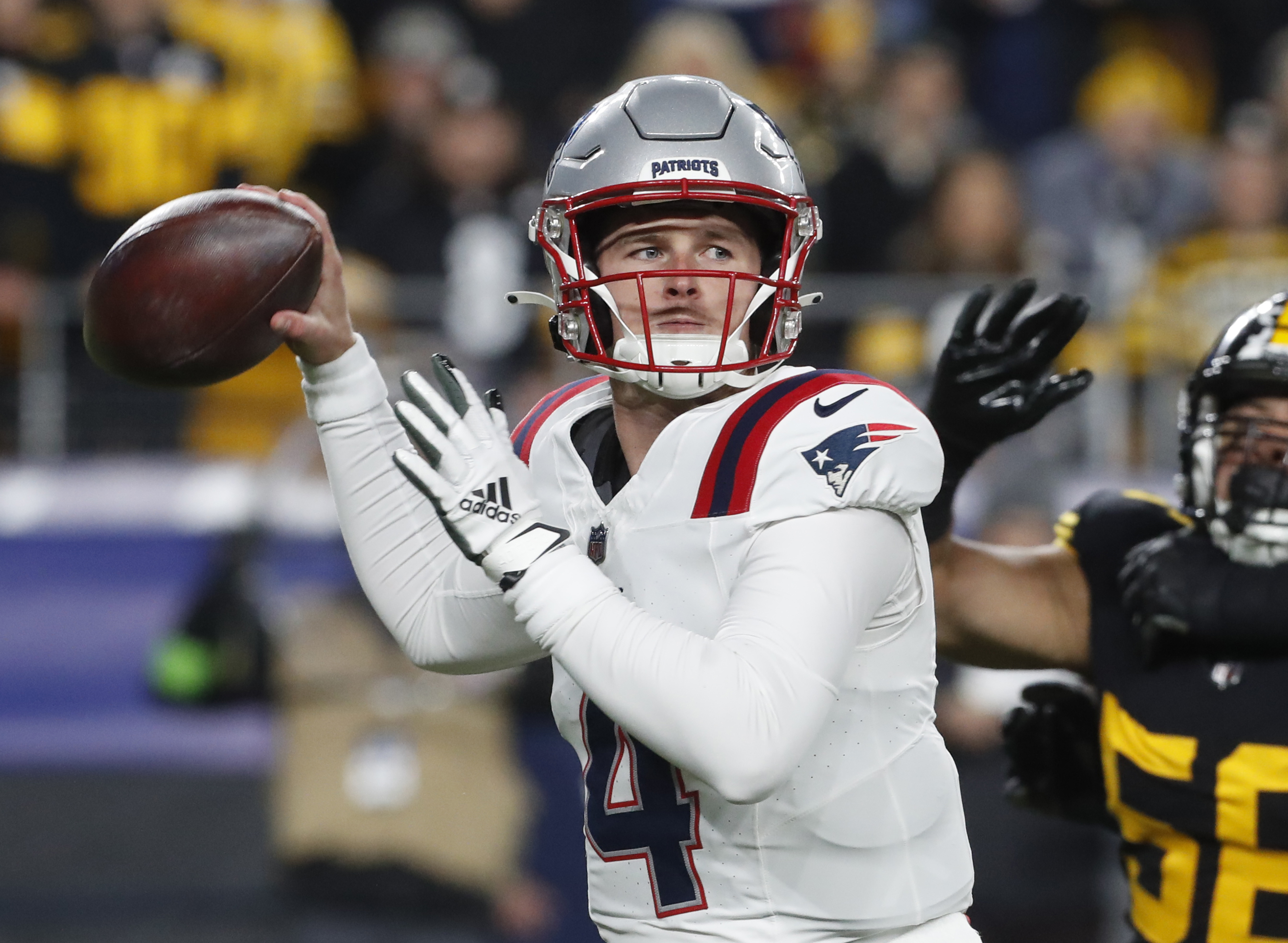 New England Patriots quarterback Bailey Zappe (4) passes the ball against the Pittsburgh Steelers during the first quarter at Acrisure Stadium.