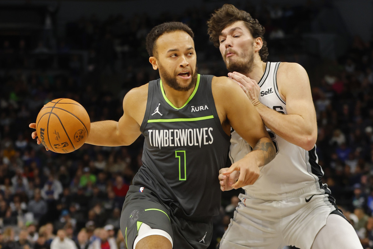 Dec 6, 2023; Minneapolis, Minnesota, USA; Minnesota Timberwolves forward Kyle Anderson (1) drives past San Antonio Spurs forward Cedi Osman (16) in the third quarter at Target Center.