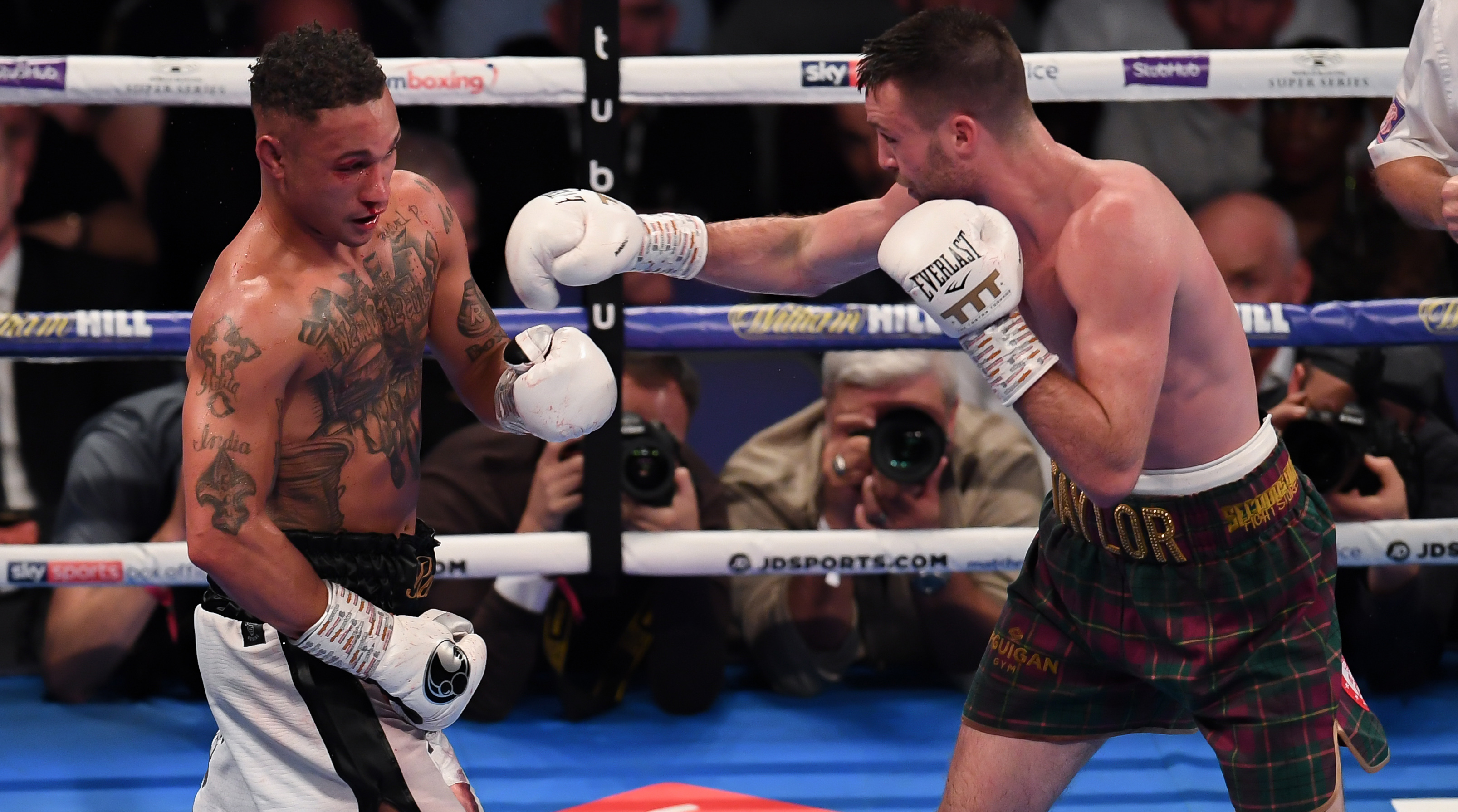 Josh Taylor throws a punch in a boxing match against Regis Prograis in 2019.