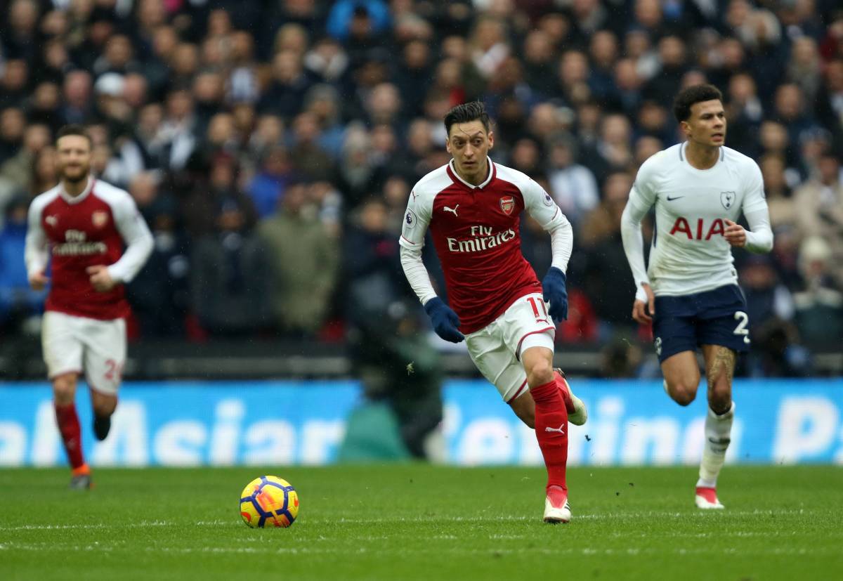 Mesut Ozil pictured (center) playing for Arsenal against Tottenham in February 2018