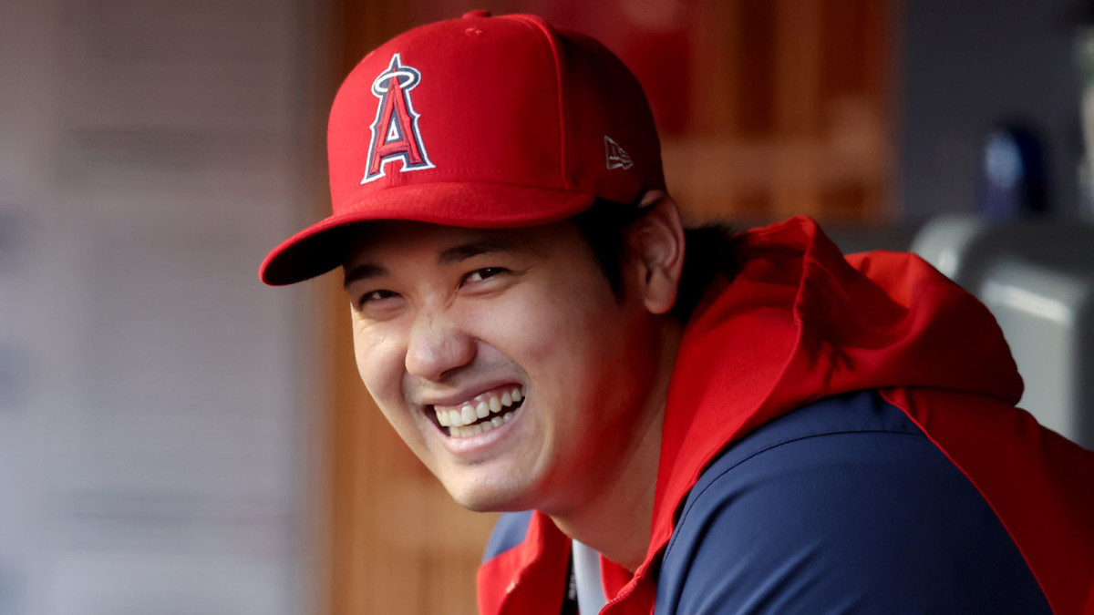 Shohei Ohtani shares a laugh in the Angels dugout.
