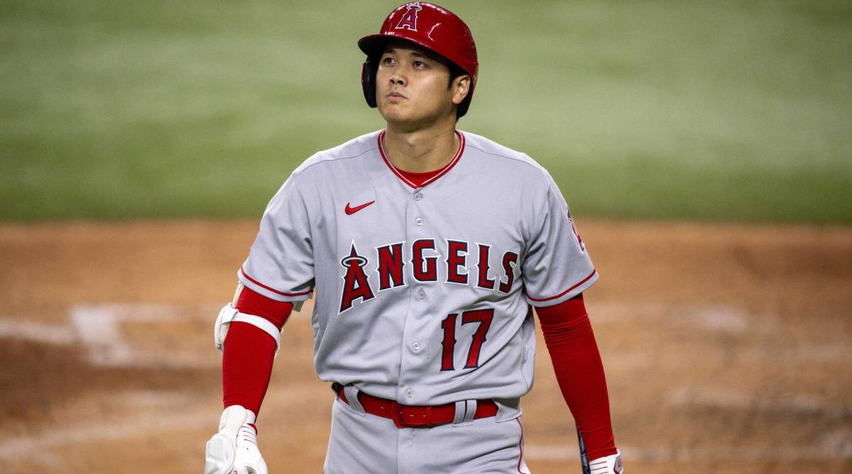 Angels superstar Shohei Ohtani walks back to the dugout after striking out in a game.