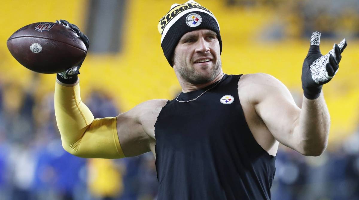 Steelers pass rusher T.J. Watt throws a ball while warming up before a game.