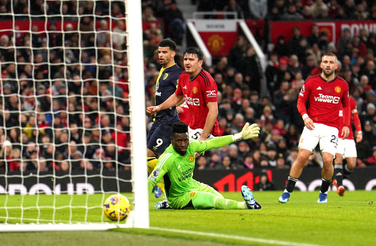 Manchester United's players pictured looking on helplessly as a fine shot from Bournemouth striker Dominic Solanke (no.9) rolls into the net during a Premier League game at Old Trafford in December 2023