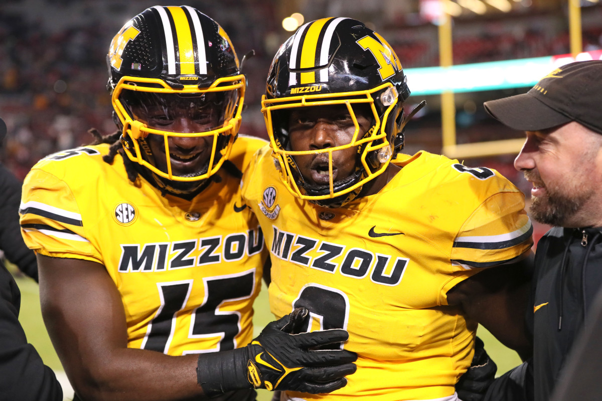Missouri Tigers defensive lineman Johnny Walker Jr (15) and Jay Jernigan celebrate after a defensive touchdown by Jernigan in the third quarter against the Arkansas Razorbacks