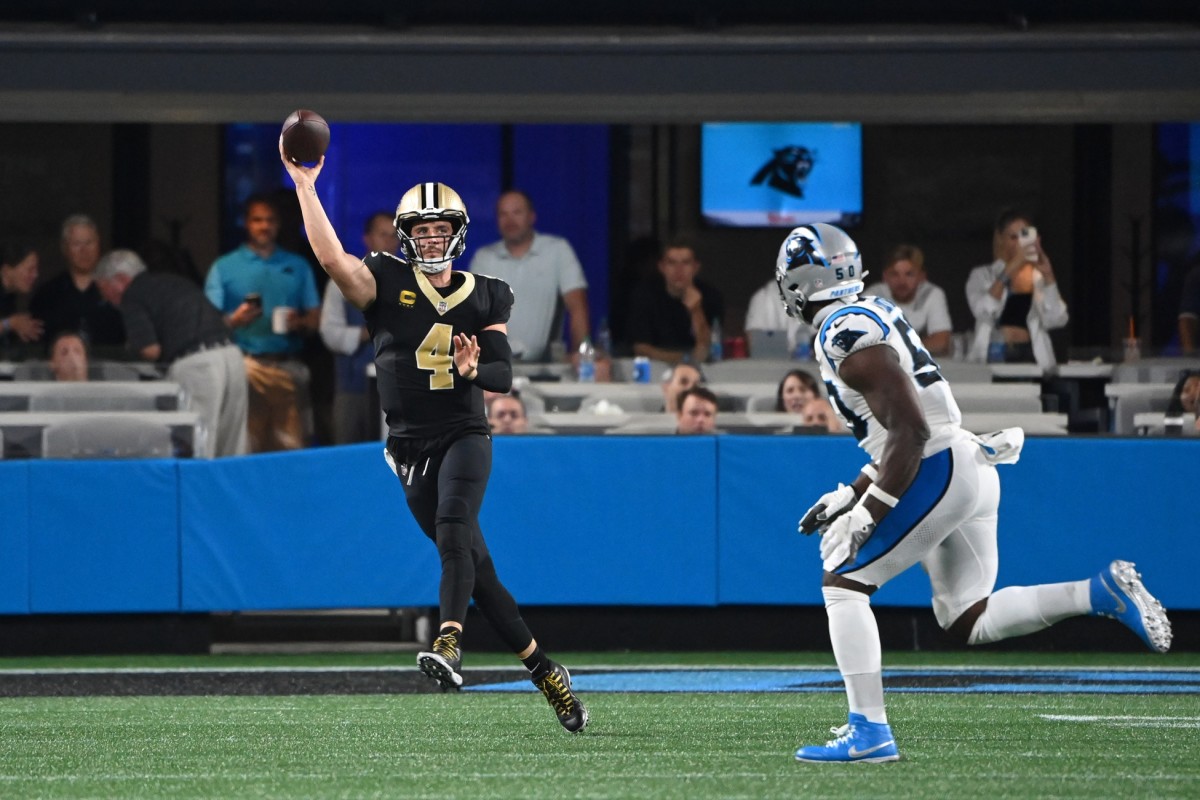 Sep 18, 2023; New Orleans Saints quarterback Derek Carr (4) passes the ball as Carolina Panthers linebacker Justin Houston (50) pursues. Mandatory Credit: Bob Donnan-USA TODAY