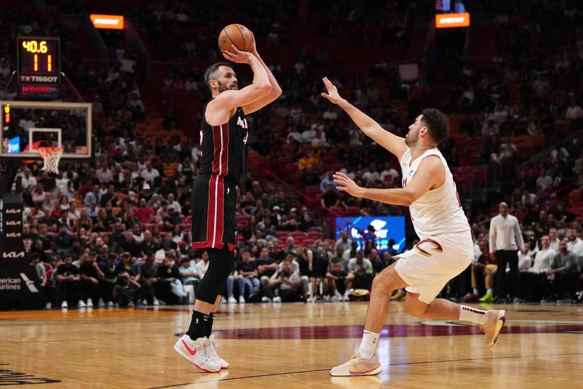 Dec 8, 2023; Miami, Florida, USA; Miami Heat forward Kevin Love (42) attempts a three point shot over Cleveland Cavaliers forward Georges Niang (20) during the first half at Kaseya Center.
