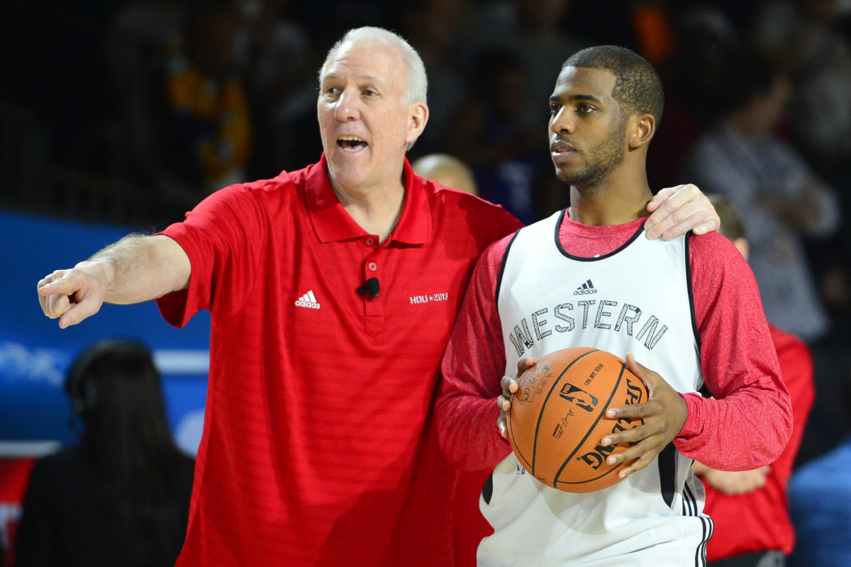 Feb 16, 2013; Houston, TX, USA; Western Conference head coach Gregg Popovich of the San Antonio Spurs talks with guard Chris Paul (3) of the Los Angeles Clippers during practice for the 2013 NBA All-Star game at the George R. Brown Convention Center.