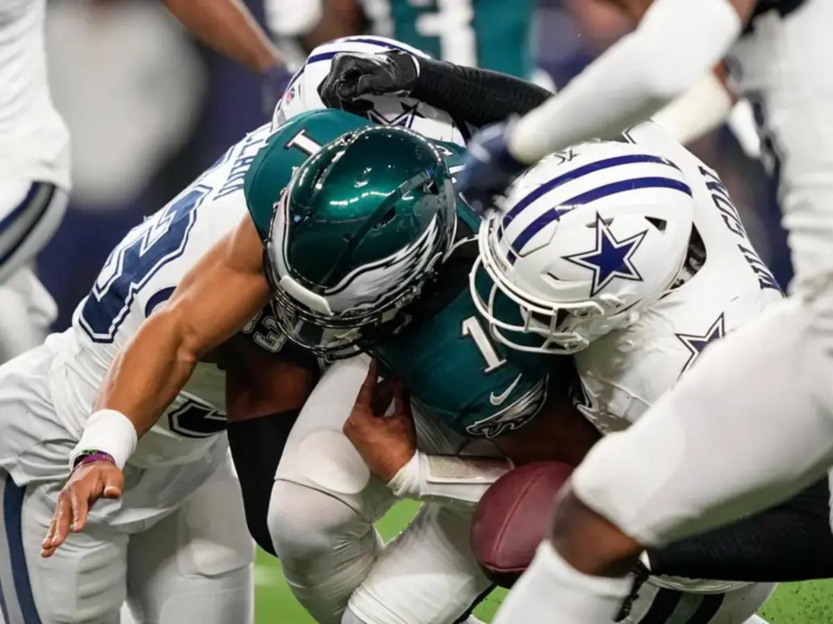 Cowboys defenders bring down Hurts during Sunday's game.