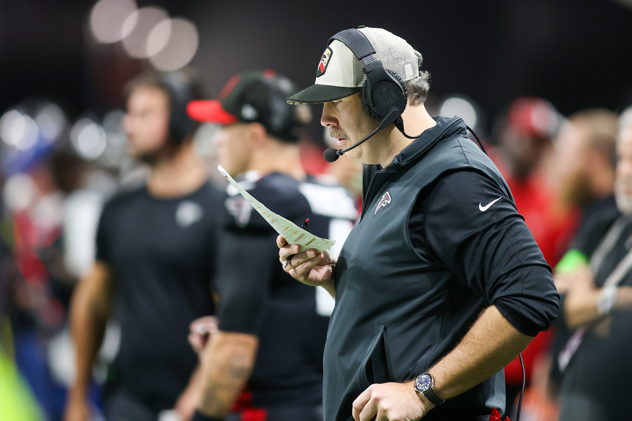 Atlanta Falcons head coach Arthur Smith looks at a play sheet against the Tampa Bay Buccaneers in the first half at Mercedes-Benz Stadium.