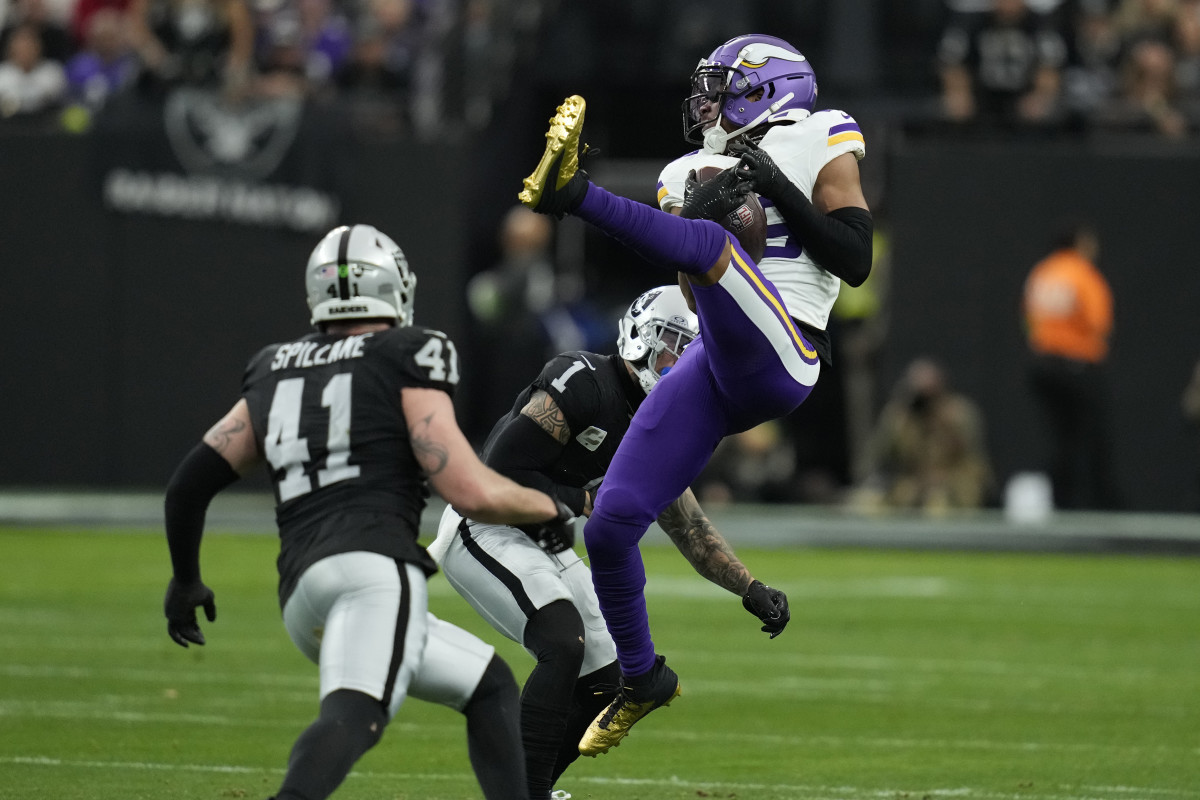 Minnesota Vikings wide receiver Justin Jefferson makes a catch as Las Vegas Raiders safety Marcus Epps (1) defends during the first half in Las Vegas. (AP Photo/John Locher)
