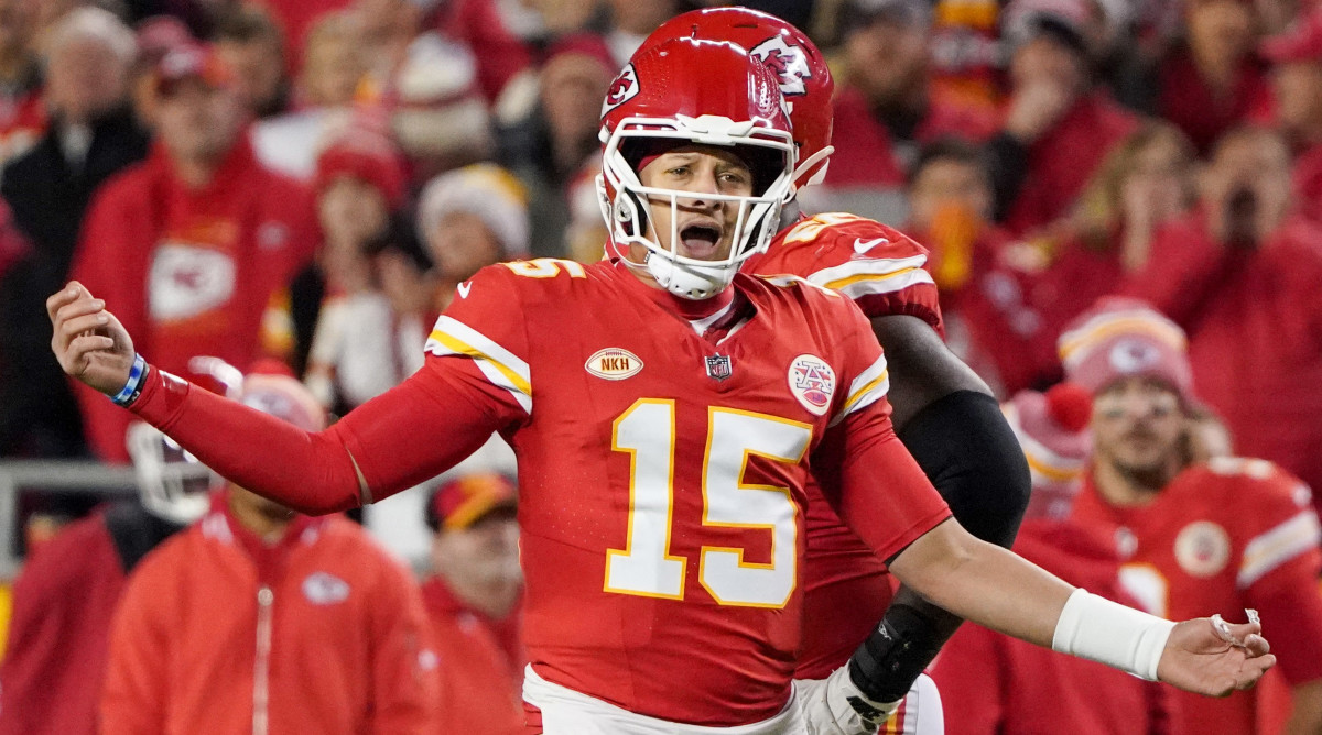 Patrick Mahomes opens his mouth as he puts two hands out to the side