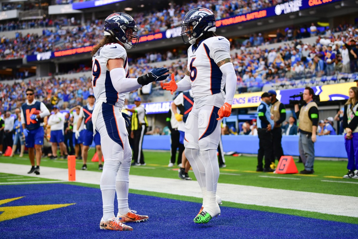Denver Broncos safety P.J. Locke (6) celebrates with linebacker Alex Singleton (49) after stopping a scoring chance by Los Angeles Chargers tight end Gerald Everett (7) during the first half at SoFi Stadium.