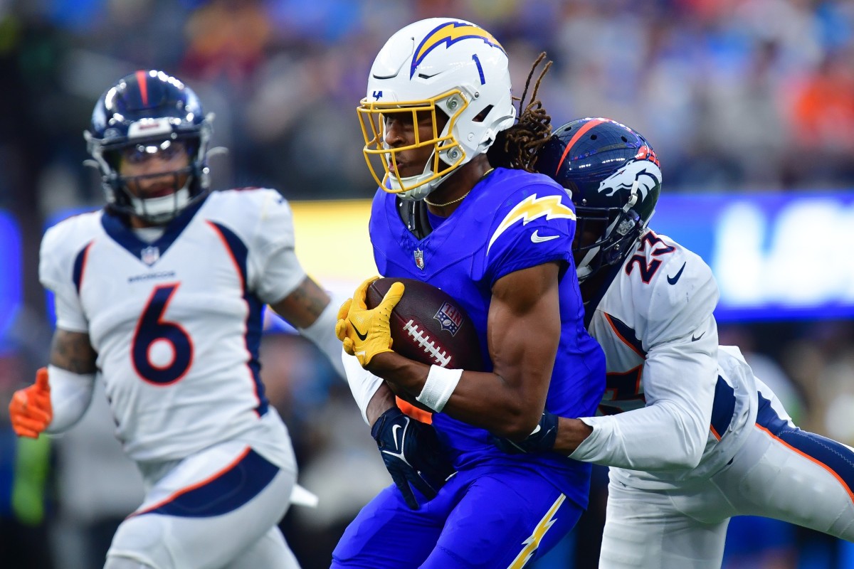 Los Angeles Chargers wide receiver Quentin Johnston (1) runs the ball against Denver Broncos cornerback Fabian Moreau (23) during the second half at SoFi Stadium.