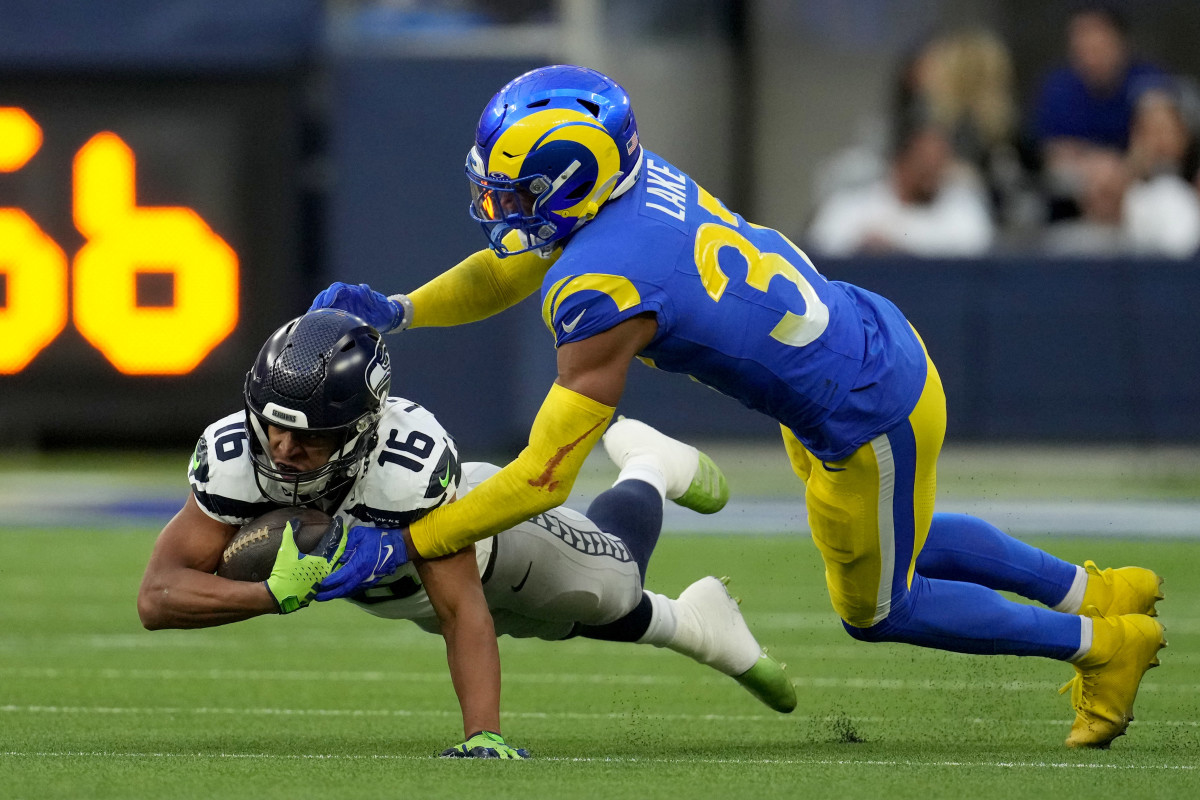 Los Angeles Rams safety Quentin Lake (37) tackles Seattle Seahawks wide receiver Tyler Lockett (16) in the third quarter at SoFi Stadium.