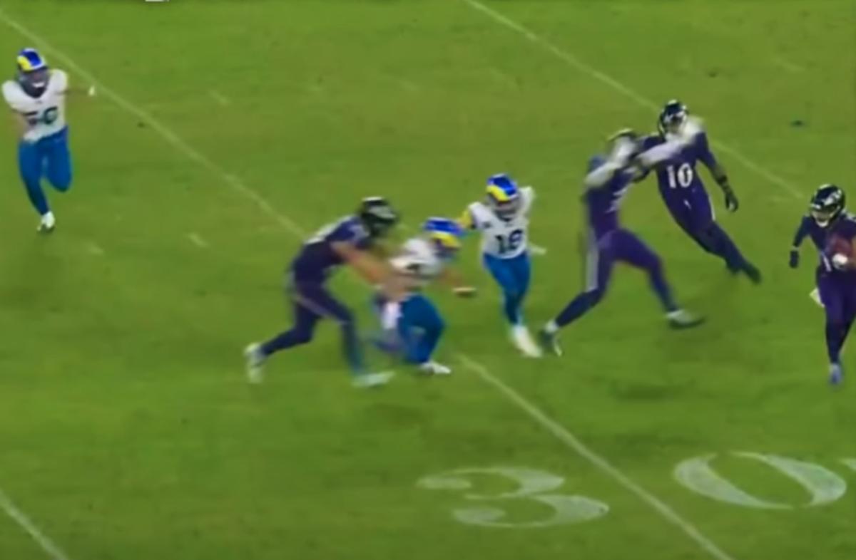 Ravens tight end Charlie Kolar appears to block Rams linebacker Jacob Hummel in the back.