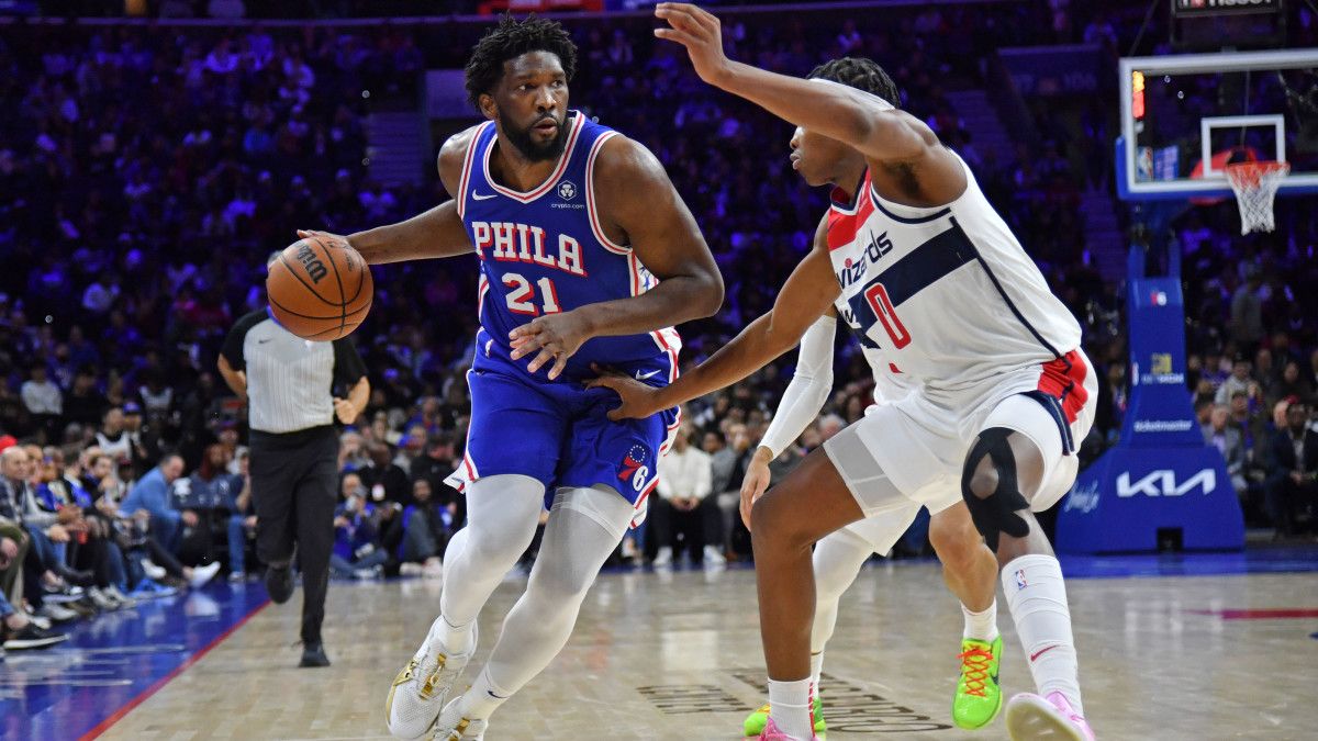 Philadelphia 76ers center Joel Embiid dribbles past Washington Wizards guard Bilal Coulibaly.