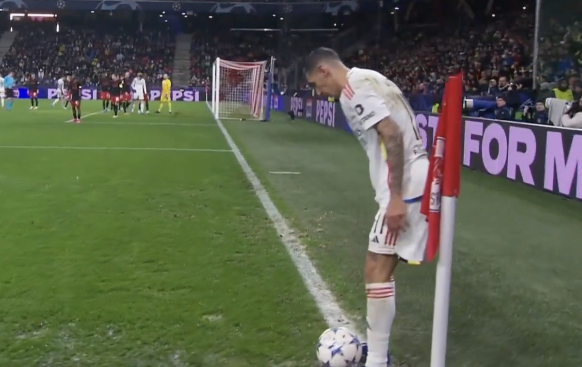 Angel Di Maria pictured standing over the ball by the corner flag moments before scoring an Olimpico goal for Benfica against RB Salzburg in the UEFA Champions League in December 2023