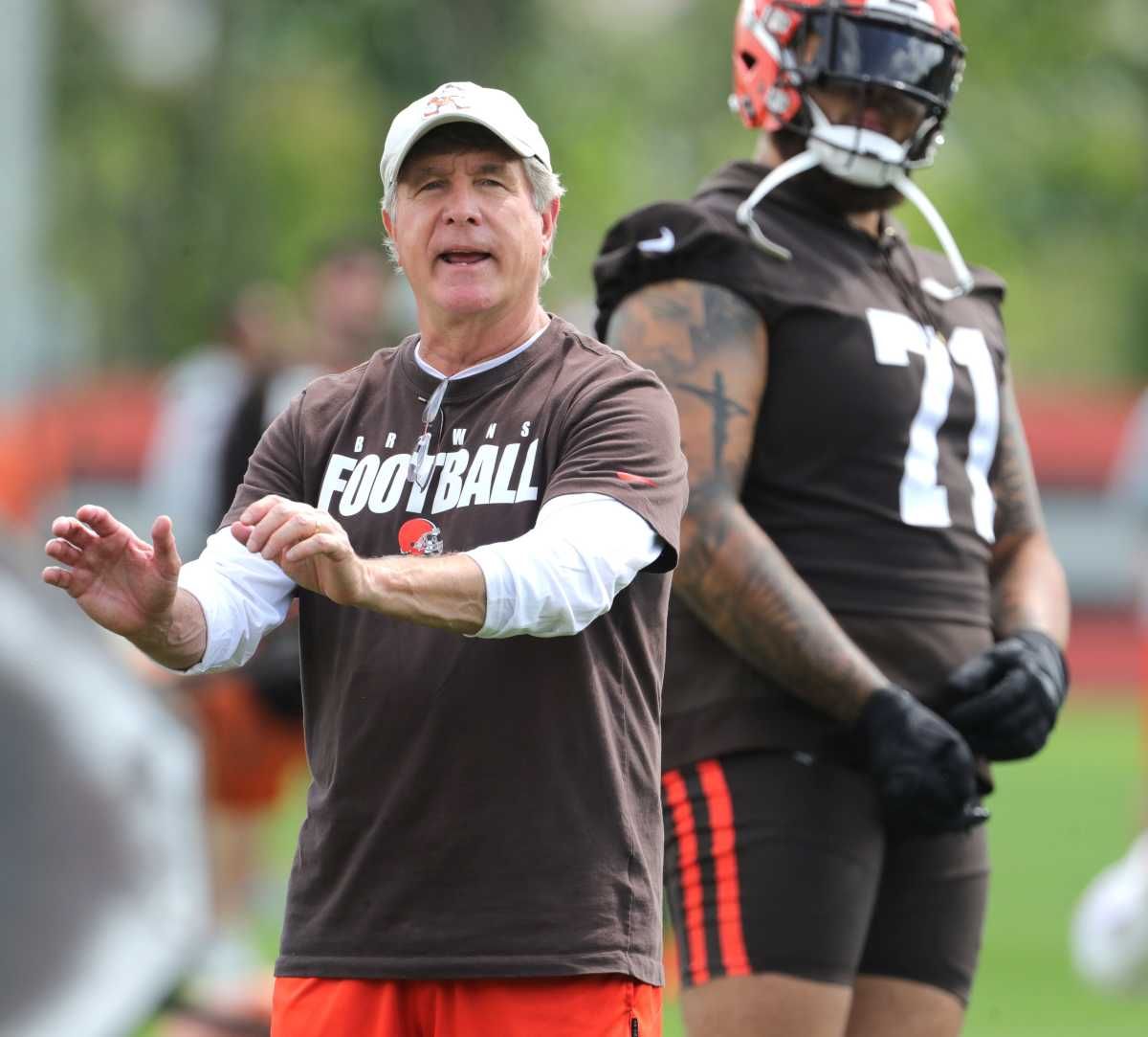 Bill Callahan puts his hands out in a gesture as he coaches