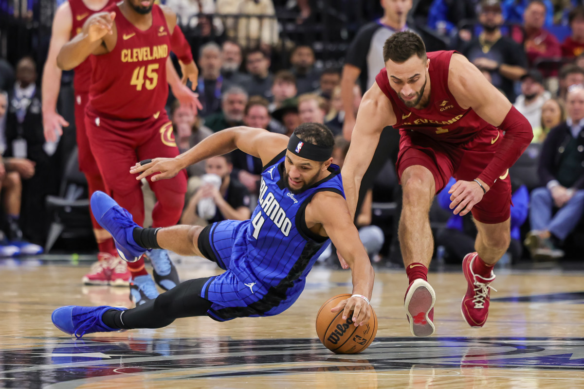 Orlando Magic guard Jalen Suggs (4) dives on the ground for a loose ball in the team's win on Monday night