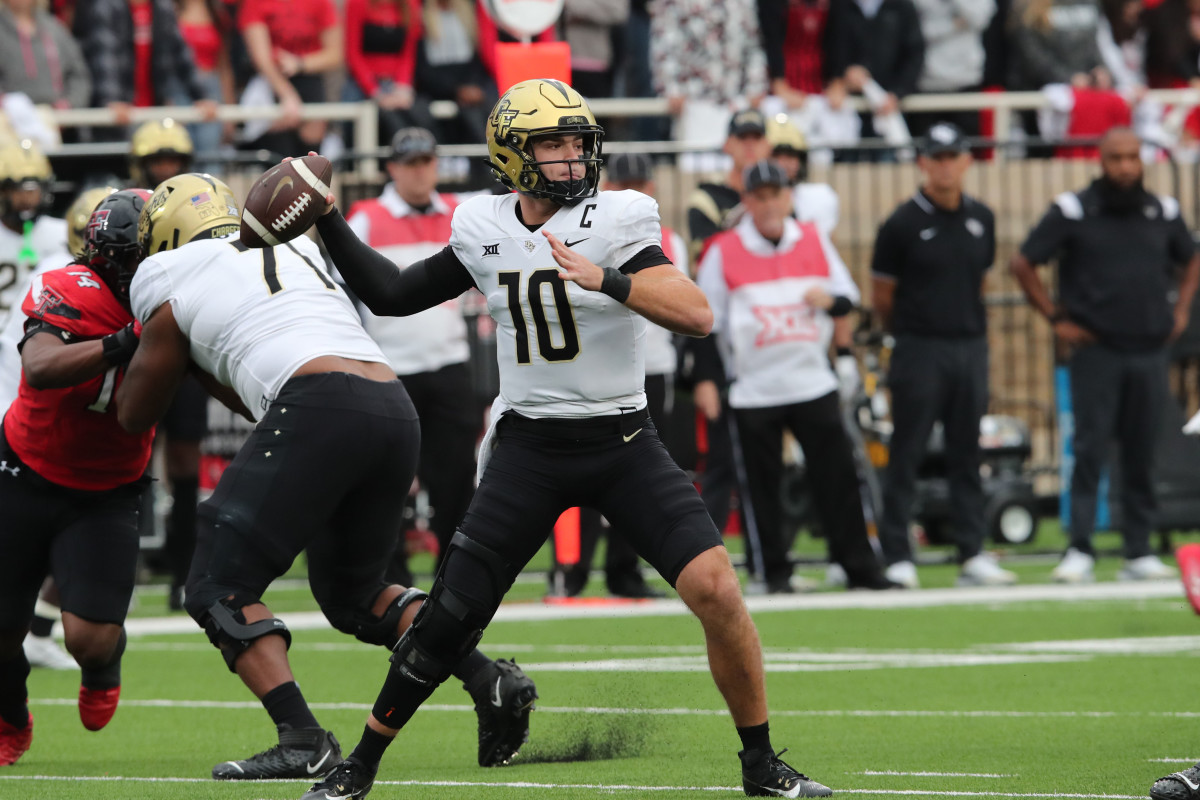 Nov 18, 2023; Lubbock, Texas, USA; Central Florida Knights quarterback John Rhys Plumlee (10) passes in the first half against the Texas Tech Red Raiders at Jones AT&T Stadium and Cody Campbell Field. Mandatory Credit: Michael C. Johnson-USA TODAY Sports