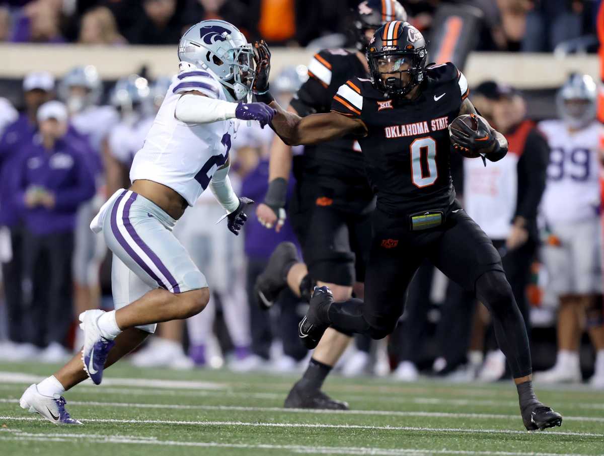 Kansas State Wildcats safety Kobe Savage attempts to tackle Oklahoma State running back Ollie Gordon II.