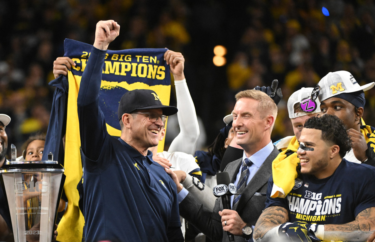 Dec 2, 2023; Indianapolis, IN, USA; Michigan Wolverines head coach Jim Harbaugh celebrates with running back Blake Corum (2) after winning the Big Ten Championship game against the Iowa Hawkeyes at Lucas Oil Stadium. Mandatory Credit: Robert Goddin-USA TODAY Sports