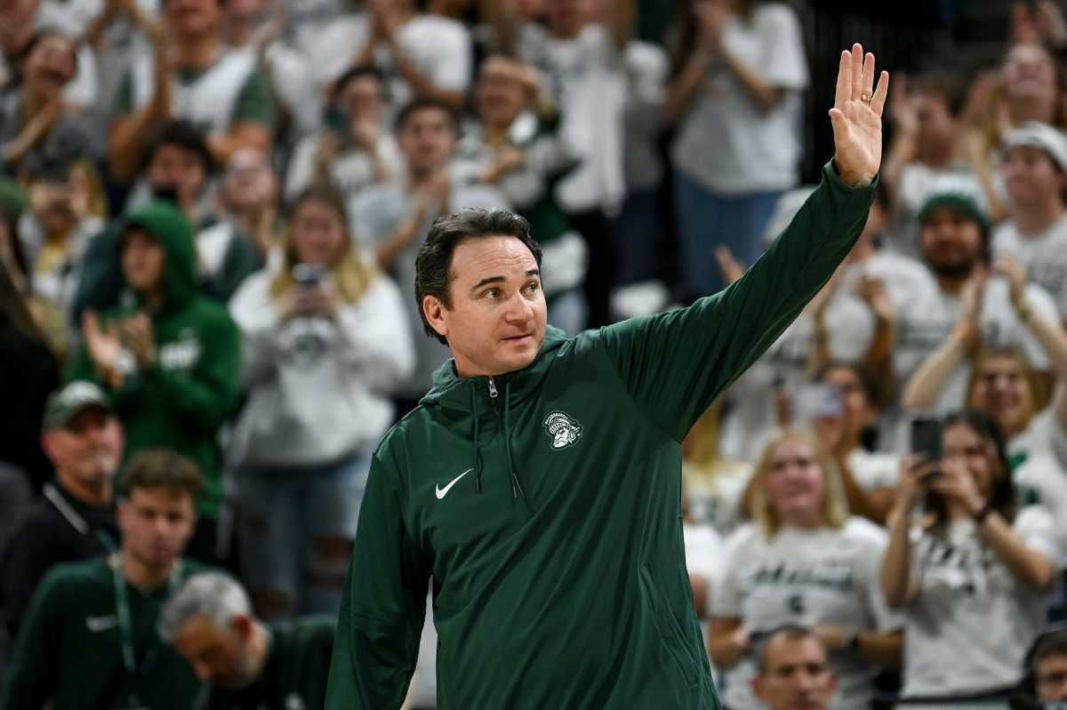 Michigan State's new football coach Jonathan Smith waves to the crowd during a timeout in the basketball game against Georgia Southern on Tuesday, Nov. 28, 2023, at the Breslin Center in East Lansing.
