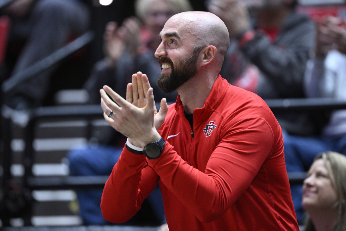 Dec 9, 2023; San Diego, California, USA; San Diego State Aztecs football coach Sean Lewis applauds during the first half of the game between the Aztecs and the UC Irvine Anteaters at Viejas Arena. Mandatory Credit: Orlando Ramirez-USA TODAY Sports