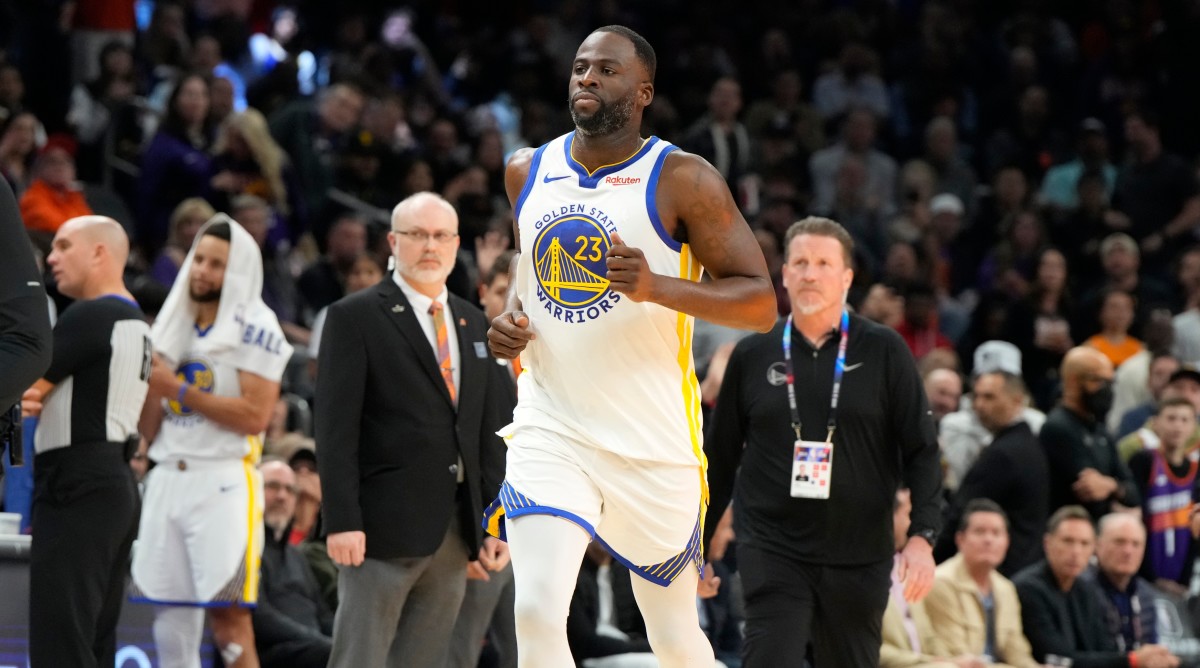 Warriors forward Draymond Green runs off the court after getting ejected during a game against the Suns.