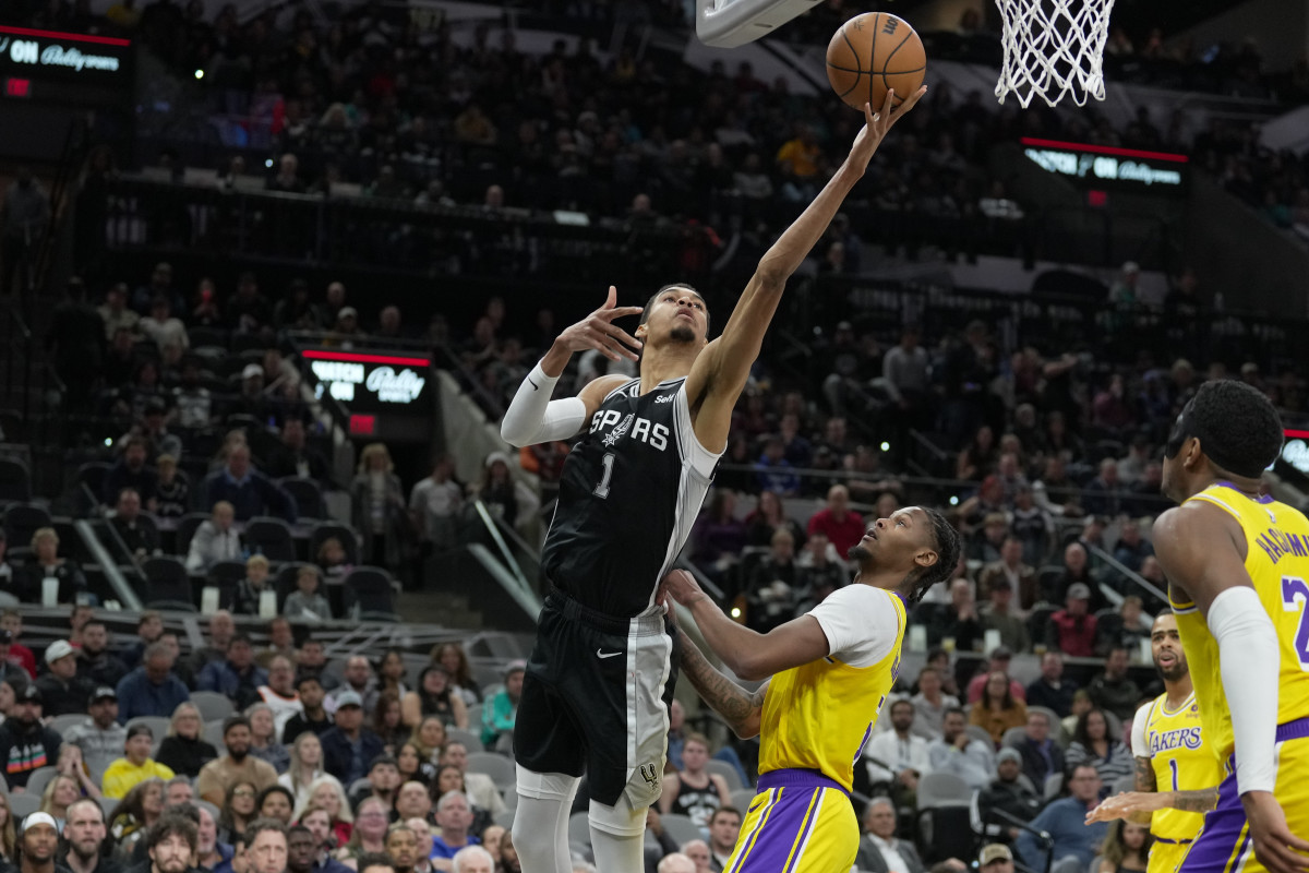 Dec 13, 2023; San Antonio, Texas, USA; San Antonio Spurs center Victor Wembanyama (1) shoots over Los Angeles Lakers forward Cam Reddish (5) in the first half at the Frost Bank Center.
