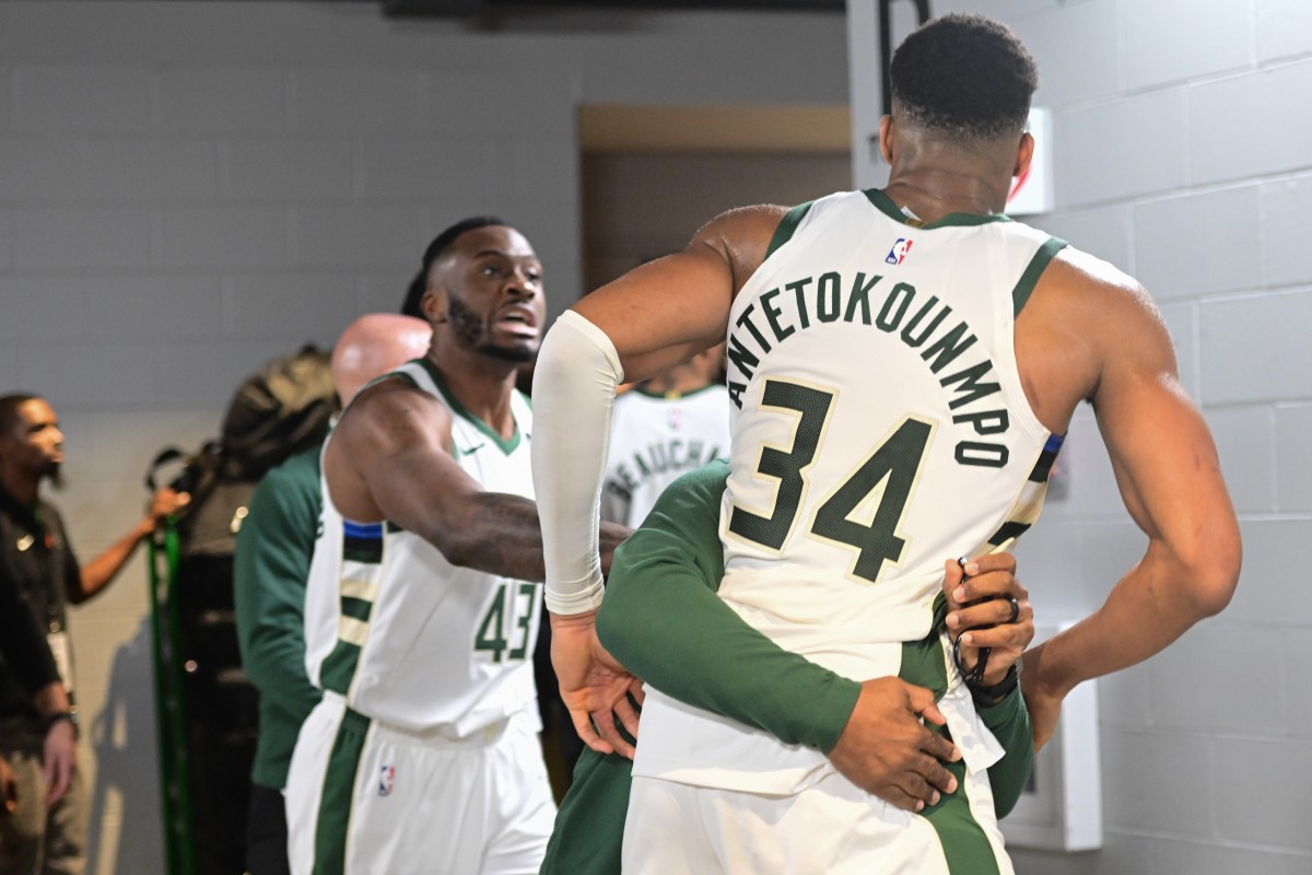 Milwaukee Bucks forward Giannis Antetokounmpo (34) is restrained by a coach outside the Indiana Pacers locker room