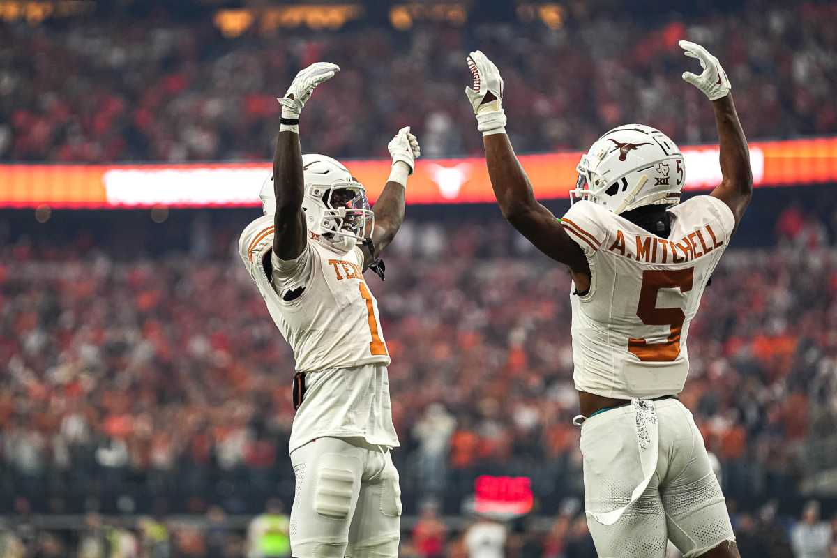 Texas Longhorns wide receivers Adonai Mitchell (5) and Xavier Worthy (1) celebrate a touchdown by Mitchell during the Big 12 Championship game against the Oklahoma State Cowboys at AT&T stadium on Saturday, Dec. 2, 2023 in Arlington.