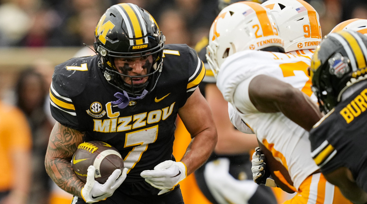 Missouri running back Cody Schrader braces for impact against a Tennessee defender